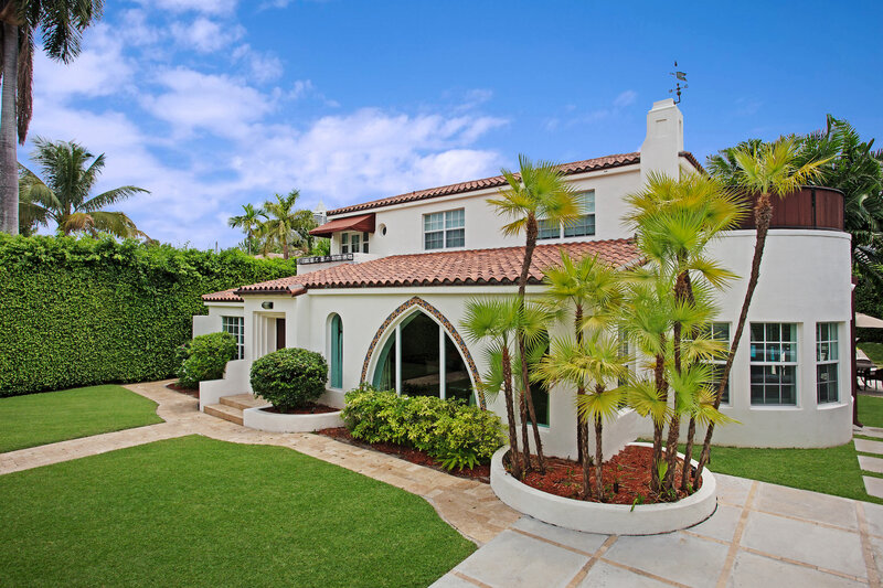 Florida home exterior with large impact windows and stucco walls